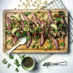 Steak salad on a wooden serving board 